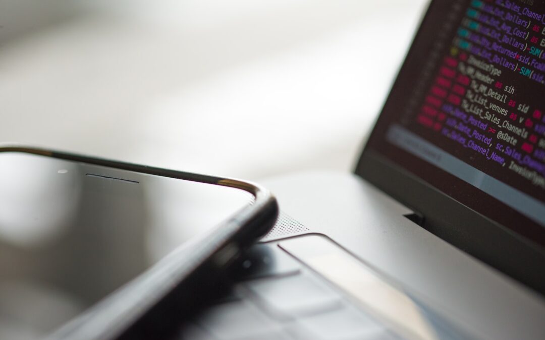 Developer reviewing AI API billing dashboard with payment workflow on laptop and phone