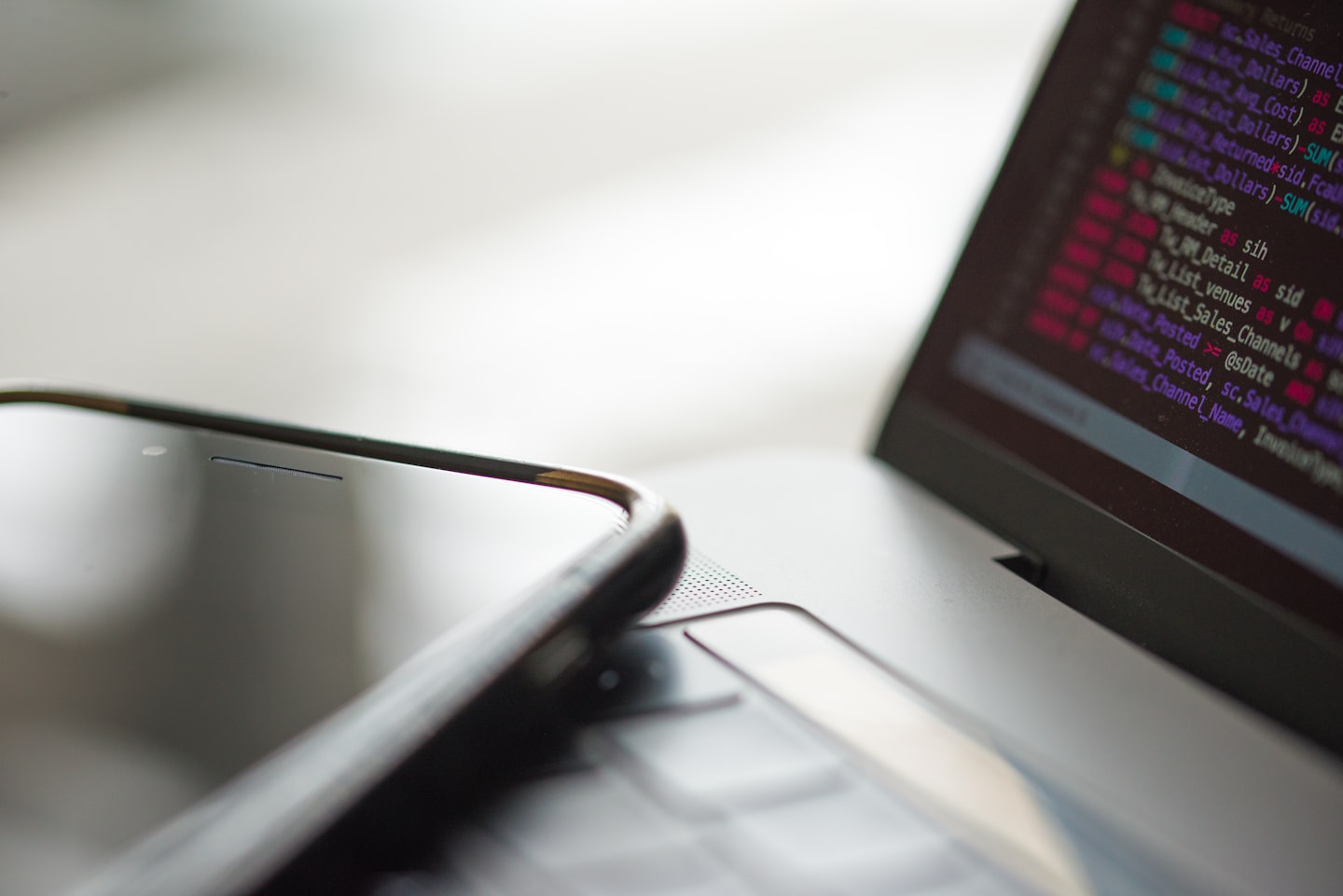 Developer reviewing AI API billing dashboard with payment workflow on laptop and phone