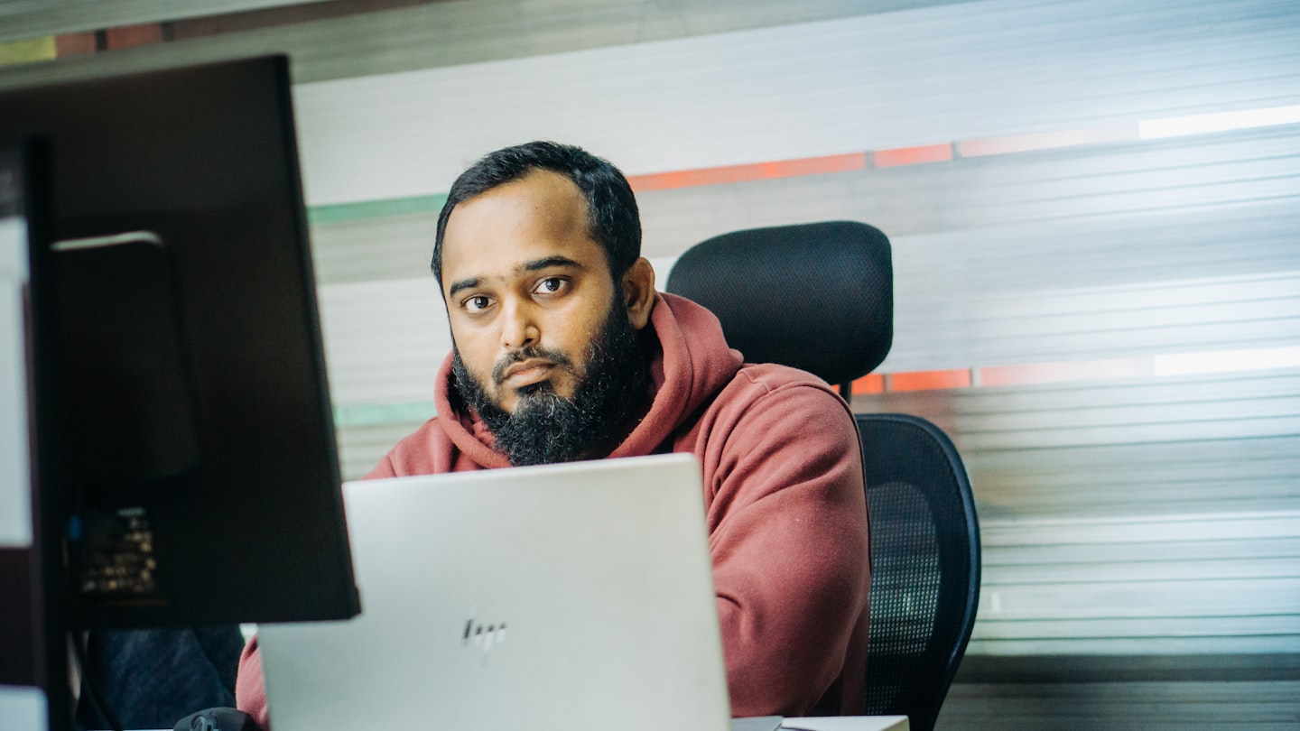 A man sitting in front of a laptop computer